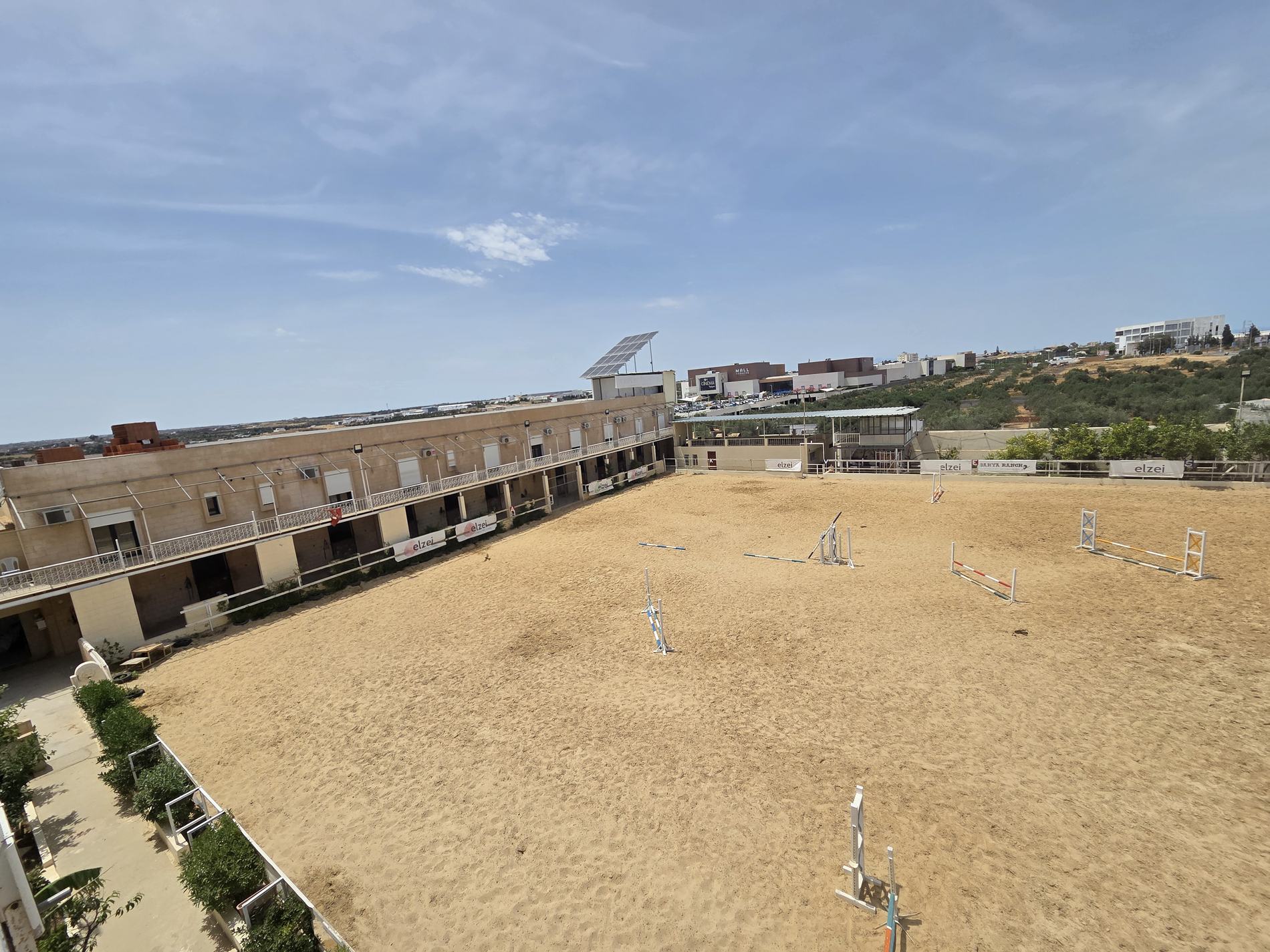 The arena and stable block seen from the upper terrace