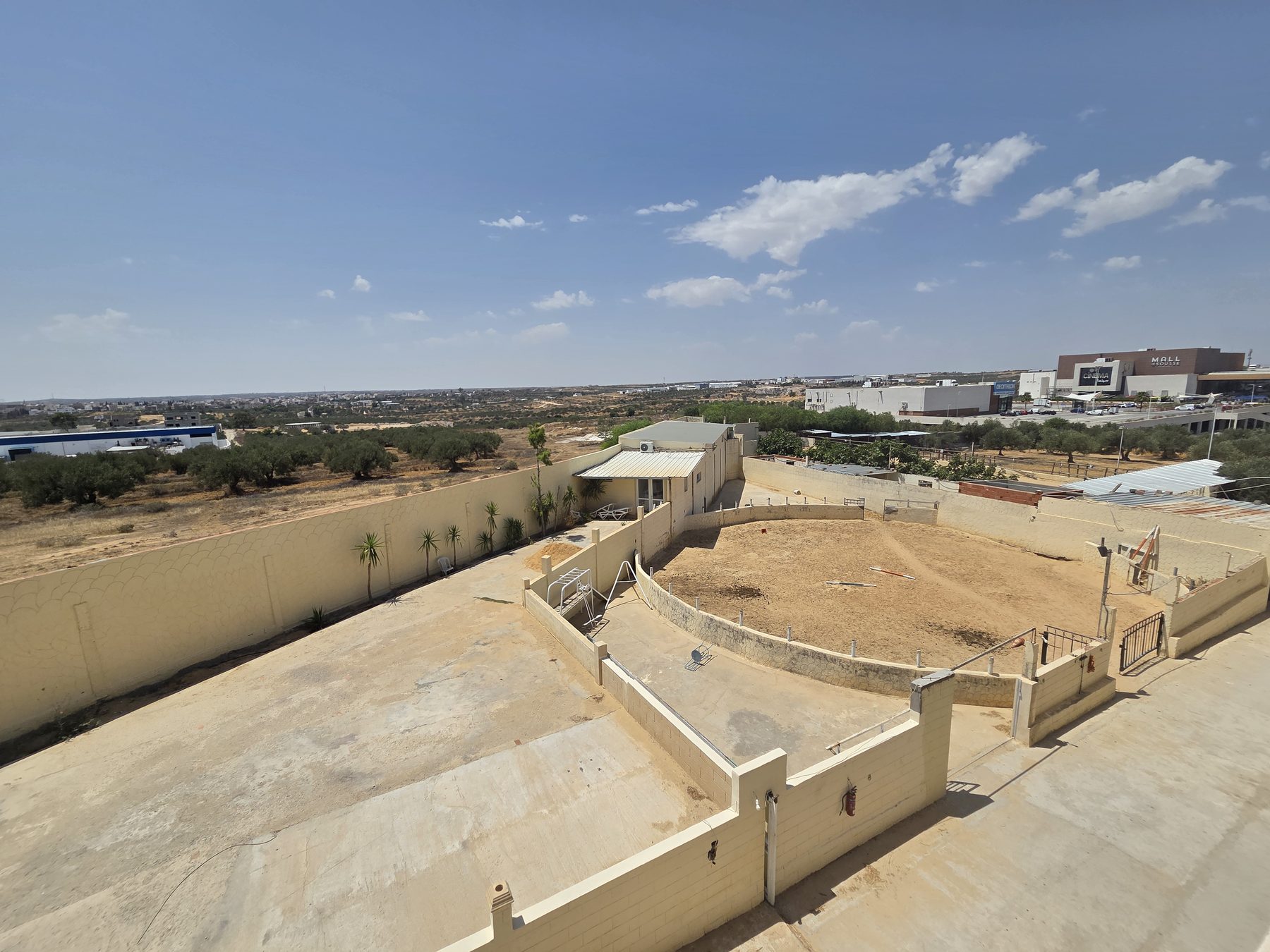 The paddock and grounds, Mall of Sousse on the horizon