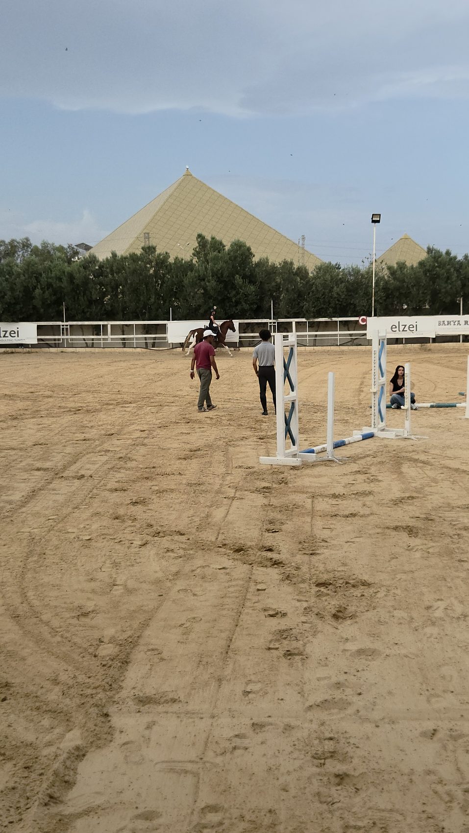 A rider working over jumps in the arena